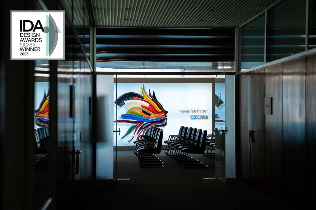 Eingang zum Showroom von FFF, groß auf einer Leuchtwand: der Filzkopf von FFF Darauf abgebildet das Siegel vom IDA Design Award Silber.